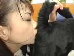 This footage shows a petite, young Asian housewife in uniform bending over and drilling a dog gazoo before licking it.